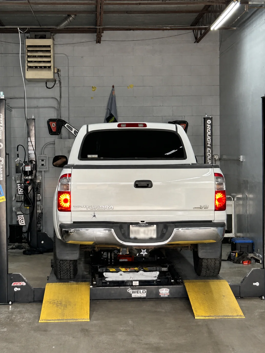 Toyota Tundra positioned on the shop's wheel alignment rack